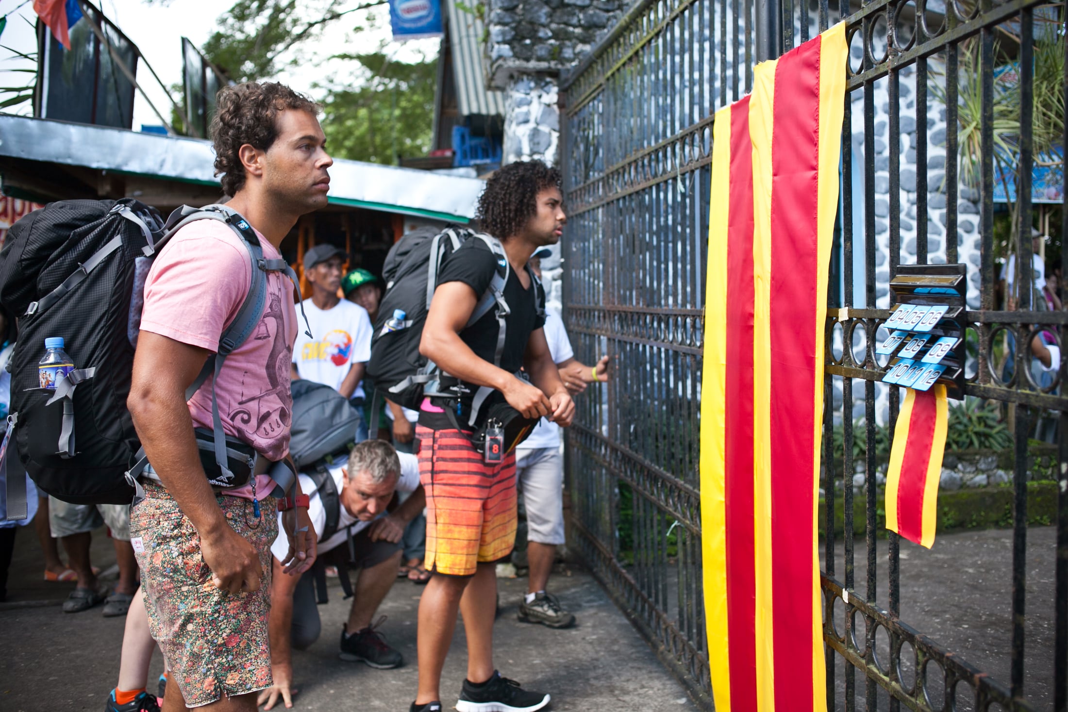 Amazing Race contestants arriving at a marked gate