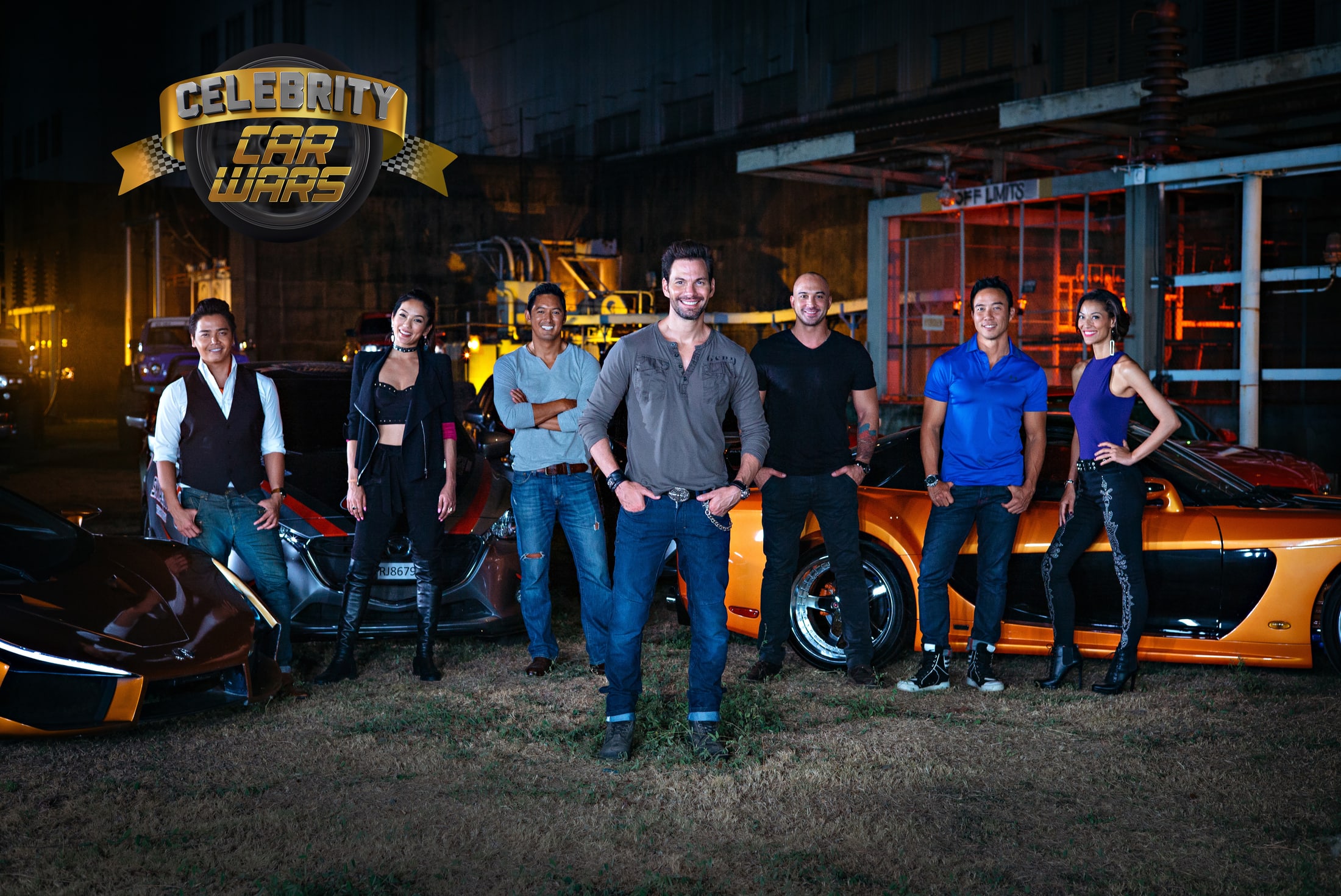 Celebrity Car Wars host Bobby Tonelli with the Season 1 cast standing among sports cars