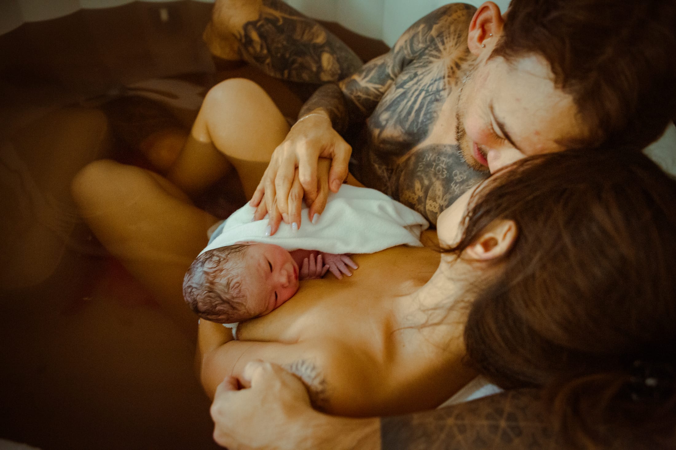 Baby E resting against Leila after birth